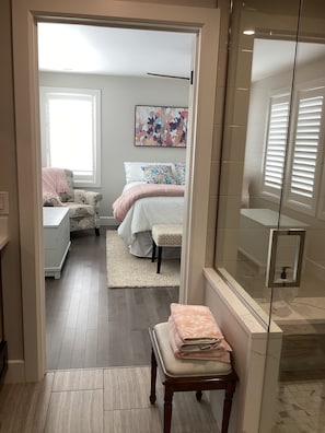 A bedroom with a bed, a chair, a bedside table, and a window. - Brand new listing this season
Hickory Lakehouse (Wheatley)