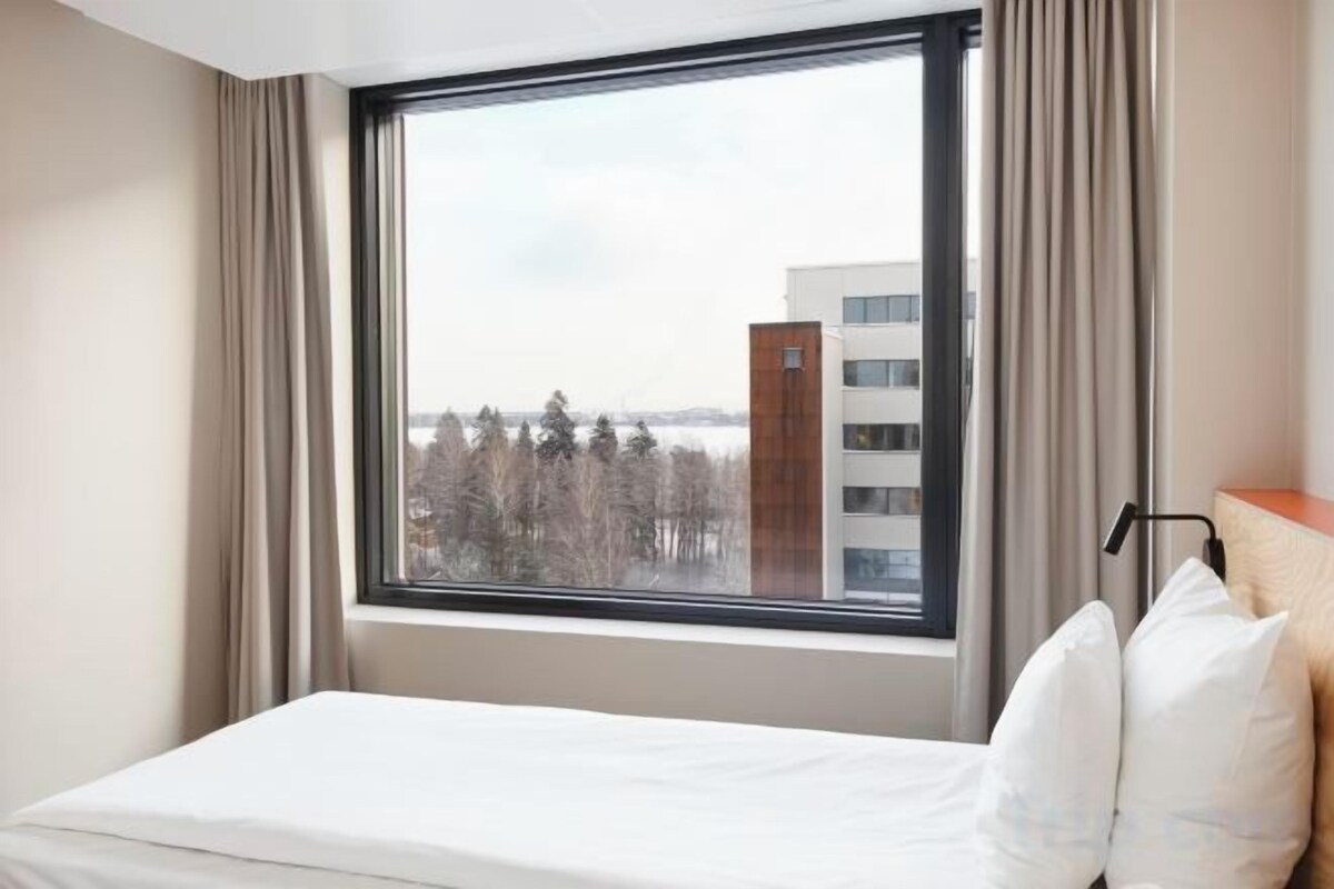Premium bedding, desk, laptop workspace, blackout drapes