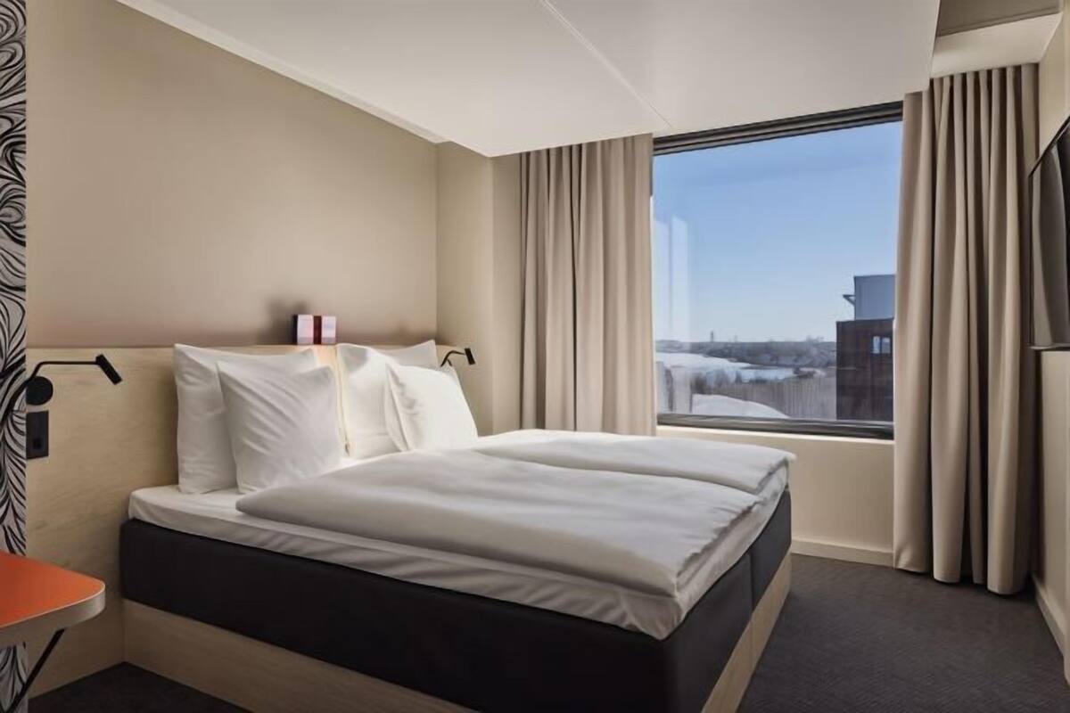 Premium bedding, desk, laptop workspace, blackout curtains