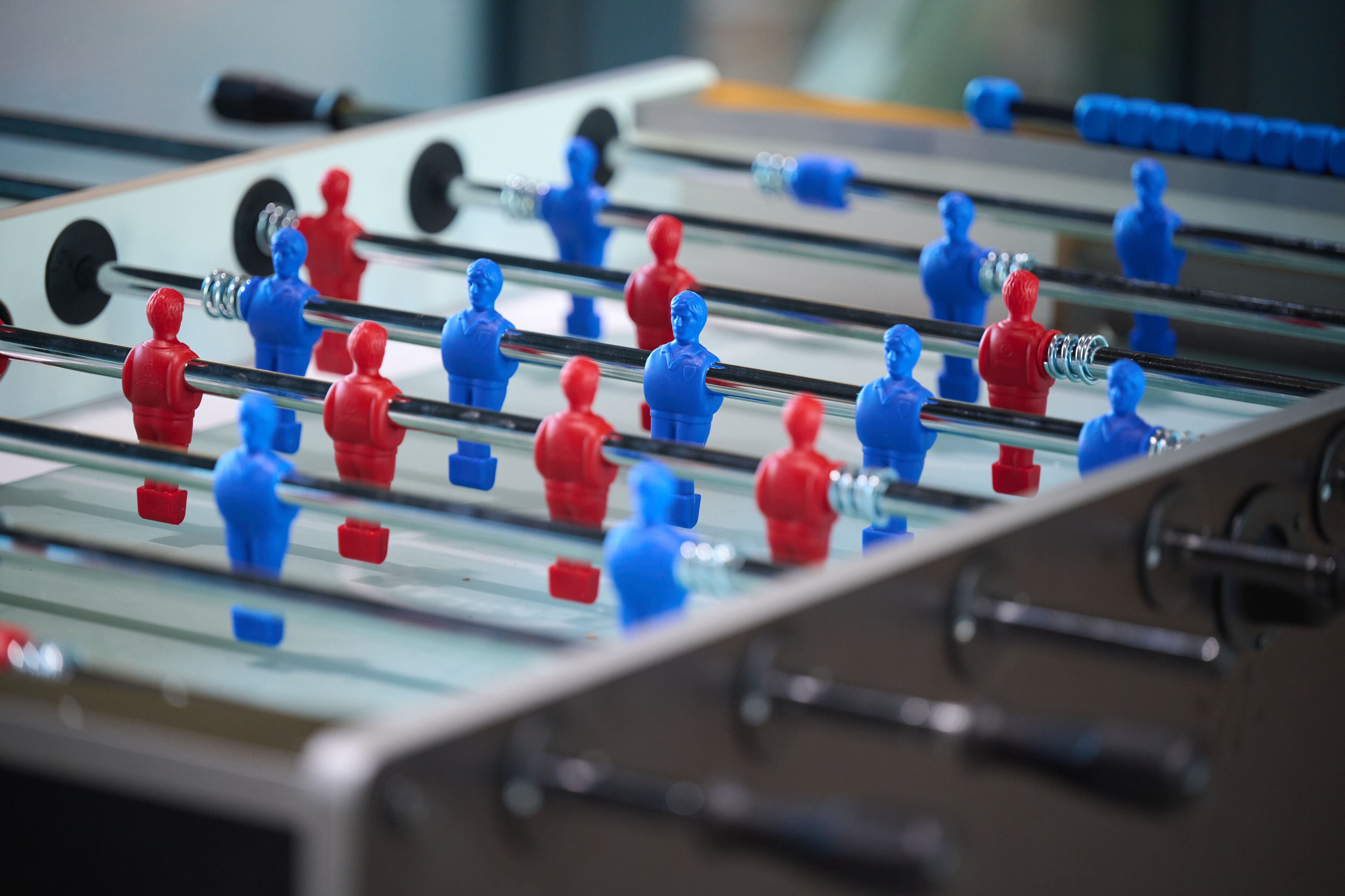 A foosball table with red and blue player figures.