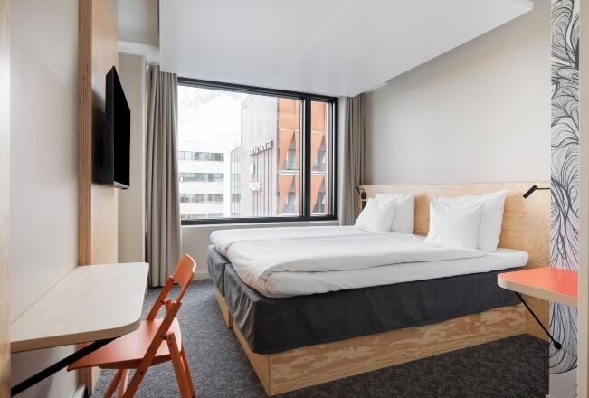 Premium bedding, desk, laptop workspace, blackout drapes