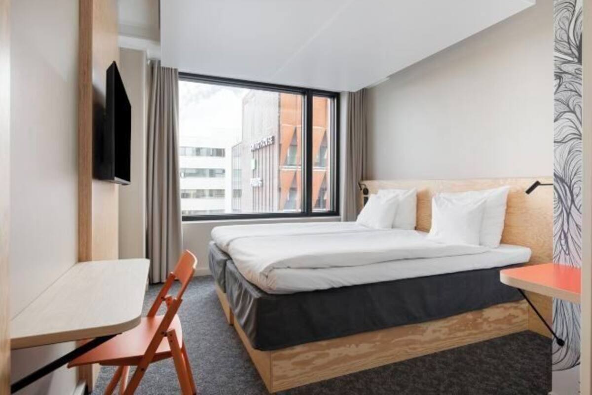 Premium bedding, desk, laptop workspace, blackout drapes