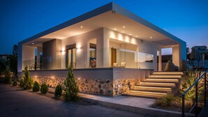 A modern house with a covered patio, stone foundation, and a staircase leading to the entrance. - Villa Amo With Private Pool (Malevizi)