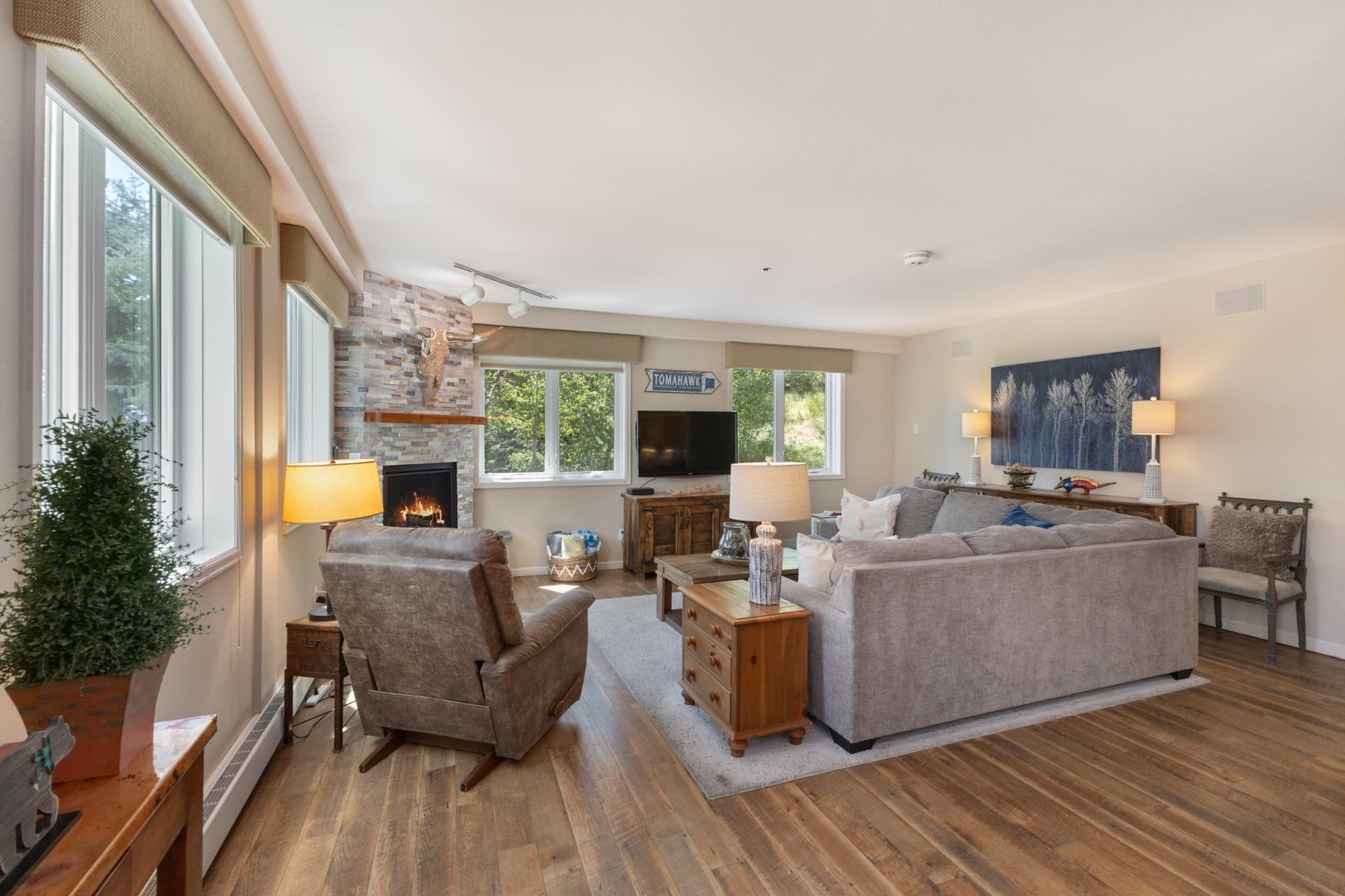 A living room with a fireplace, a television, a sofa, and a coffee table.