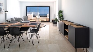 A modern kitchen with a dining area, large windows, and a view of the sea. - Lotus 2341 Golf beach & pool (Casares)