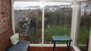 A room with a large window overlooking a parking area and a grassy field. - Perfectly located for town and beach - Victorian terraced house near East Beach. Sleeps 7 (North Berwick)