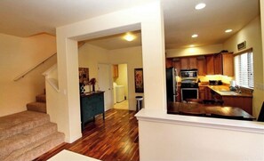 A modern kitchen with wooden cabinets, a microwave, and a stove. - LOCATION - 2 blocks to wine tasting rooms, restaurants, breweries. (Paso Robles)