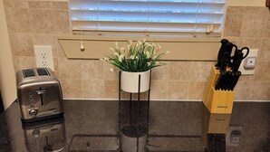 A kitchen counter with a toaster, a potted plant, and a knife block. - 10 minute Walk GA Aquarium and other Major Attractions (Atlanta)