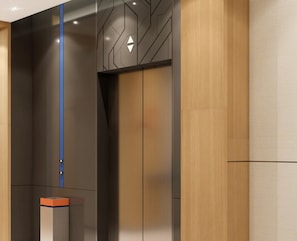 A modern elevator interior with a geometric wall design, a blue accent line, and a directional arrow sign. - Holiday Inn Express Chongqing Caiyun Lake by IHG (Chongqing)