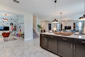 Enjoy meals in this well-equipped kitchen with a central island, sink, and ample storage.