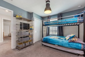 Cozy space for multiple guests, featuring a bunk bed setup and ample storage.
