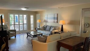 A spacious living room with a sofa, armchairs, a coffee table, and a dining table. - Sarasota 3 bedroom villa conveniently located on Palm Aire Golf Course community (Sarasota)