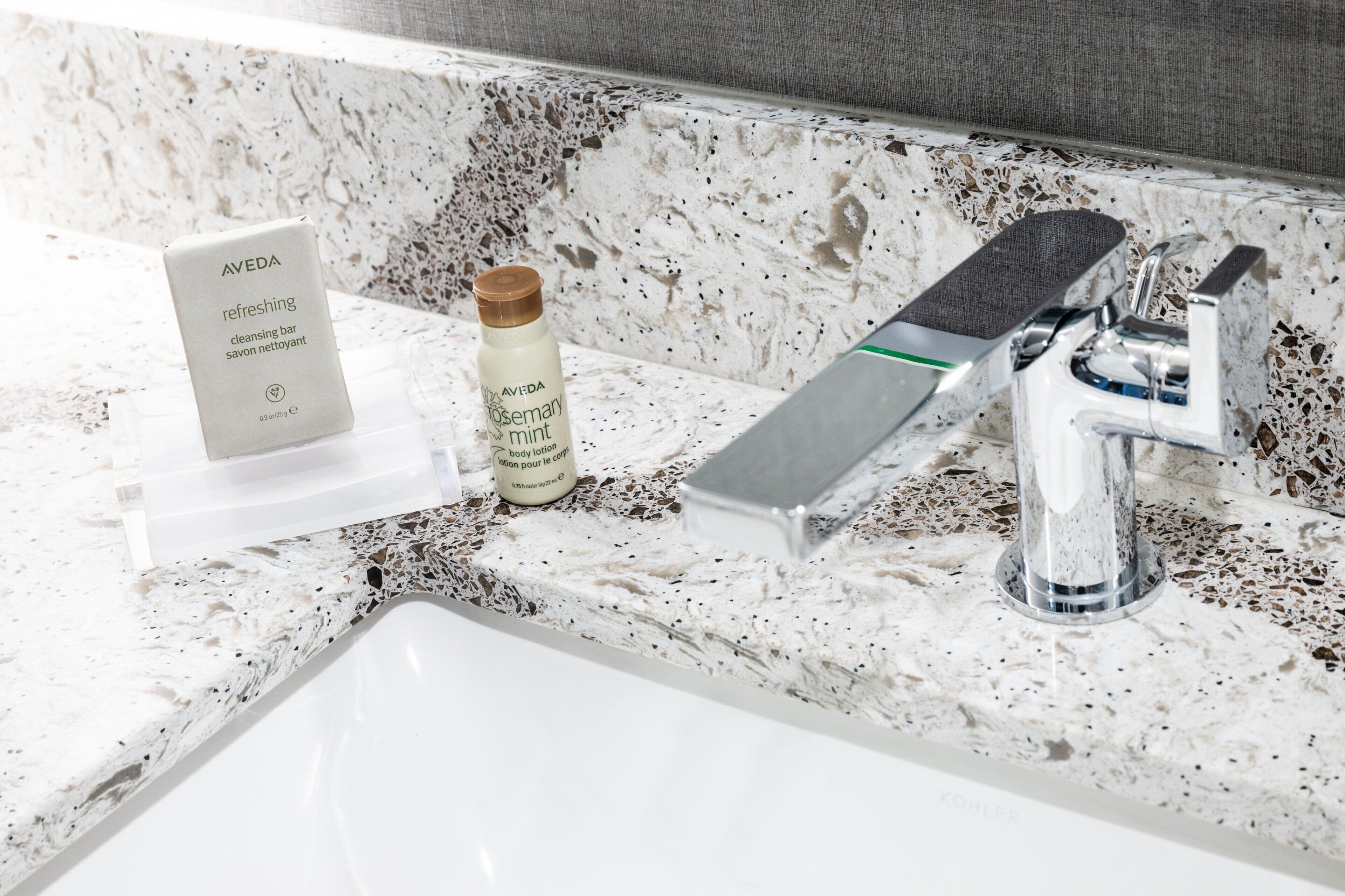 designer toiletries, hair dryer, towels