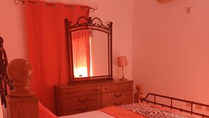 A bedroom with a bed, a dresser, a mirror, and an air conditioner. -  Enchanted at winchester kick back and relax at this modern stylish apartment  
 (Kingston)