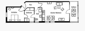 Un plan d’étage d’hôtel comprenant un salon, un coin repas, une cuisine, des chambres, une salle de bain et un balcon.