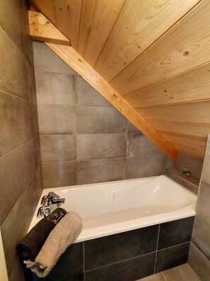 Bathtub, hair dryer, towels, soap
