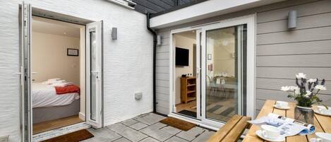 Experience a serene retreat with a bedroom, dining area, and sliding door to an outdoor space.