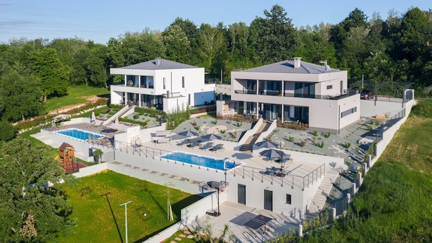 A modern two-story house with a swimming pool, outdoor seating, and a basketball court. - Luxury Villa Phoenix with Pool (Labin)