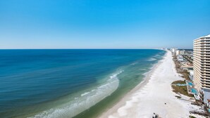 A coastal hotel with a beach view, multiple floors, and a pool area. - Treasure Island 1904 (Panama City Beach)