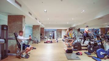 A gym with various exercise equipment, including treadmills and weight machines.