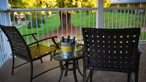 A patio with two chairs, a table, and a bucket labeled "Foothills Motel". - The Foothills Motel (Auburn)