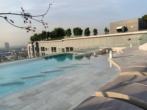 High Rise condominium with outdoor pool with view on rooftop.