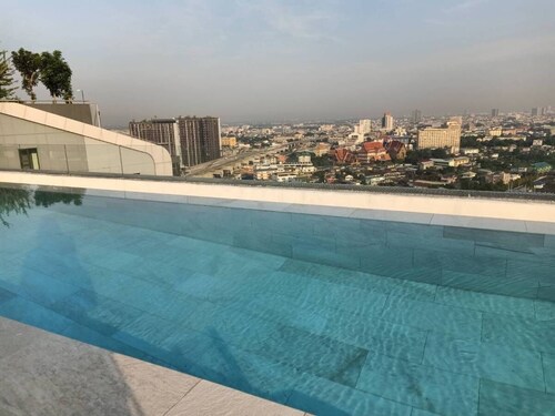 High Rise condominium with outdoor pool with view on rooftop.