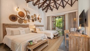 A hotel room with two beds, a wooden desk, a chair, a TV, and a large window with a view of greenery. - Casa Jacaranda Hotel Boutique - Cauca Viejo - Mayores de 14 años (Jericó)