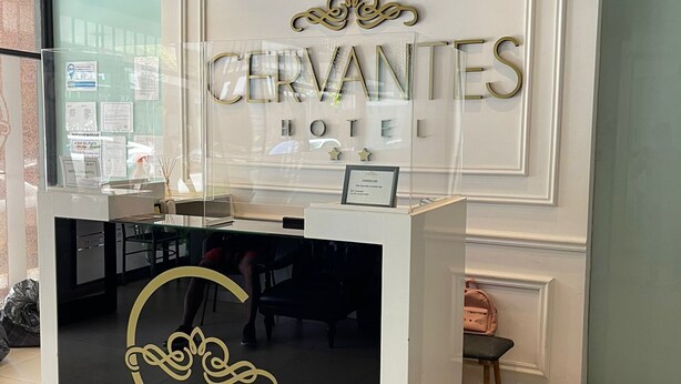A hotel reception desk with a sign that reads "CERVANTES HOTEL". - Hotel Cervantes (Mar del Plata)