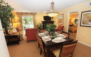 Enjoy meals in style with a dining table set for four, comfortable seating, and a beautiful view.