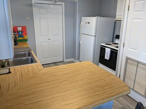 Enjoy cooking in this kitchen with a sink, refrigerator, and stove.