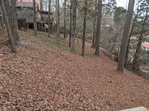 Surrounded by tall trees, this secluded retreat features multiple-level wooden structures blending into the natural landscape.