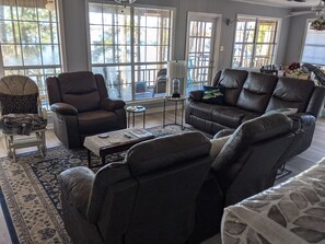 Relax in comfort on the large leather sofa set, perfect for socializing or unwinding.