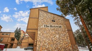 A building with a stone facade and a sign that reads "The Retreat." - Quick Walk to lift and town (Breckenridge)
