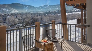 A balcony with a table set for breakfast, overlooking a snowy mountain landscape. - Lodge-style First-Class Resort. Gondola outside-SOOOO Convenient! Sleeps 4 (Park City)