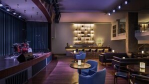 A bar area with a counter, seating, and a barista station. - Le Méridien Goa, Calangute (Calangute)
