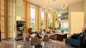 A modern hotel lobby with a marble floor, large windows, and contemporary furniture. - SQ Boutique Hotel (Bangkok)
