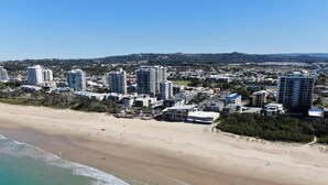 A coastal cityscape with high-rise buildings, a sandy beach, and a clear blue sky. - Coral Sea Apartments (Maroochydore)