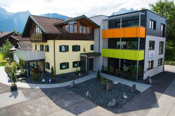 A modern building with a traditional wooden structure and a contemporary glass section.