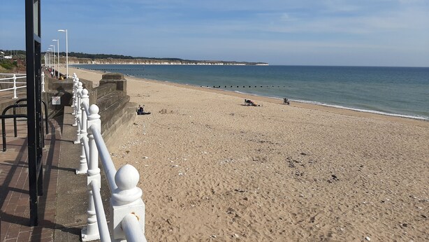 A beach with a paved walkway and a railing. - Family friendly, 3 bedrooms with parking & garden. Close to beach and town. (Bridlington)
