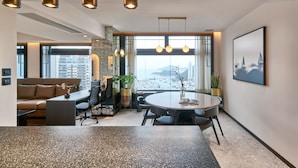 A modern office space with a round table, leather seating, and a view of the beach. - The Arca (Hong Kong)