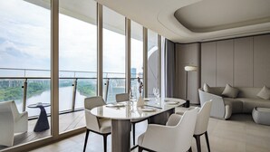 A modern dining area with a round table, chairs, and a view of a river and cityscape through large windows. - Guangzhou Xanadu Hotel, Vignette Collection by IHG (Guangzhou)
