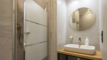 Signature Apartment | Bathroom | Shower, free toiletries, hair dryer, slippers