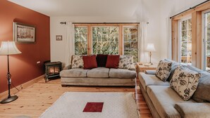 A cozy living room with a sofa, a coffee table, and a fireplace.