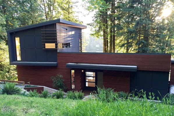 Situated in a lush environment, this two-story building offers a serene setting surrounded by trees and vegetation.