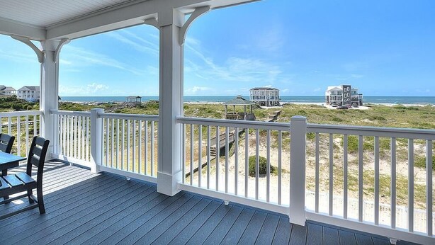 A covered outdoor area with a view of the beach and ocean. - Experience luxury at 'Gratitude' in Oak Island, a spacious 5-bedroom ocean-view retreat. (Oak Island)