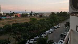 A parking lot with cars and a building in the background. - Jomtien Beach Condominium Jbc A2 F4 R28 (Pattaya)