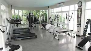 A gym with treadmills, stationary bikes, and elliptical machines.