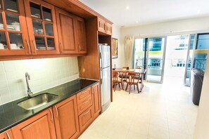 Condo, 1 Bedroom | Private kitchen | Microwave, electric kettle, dining tables
