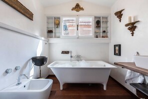 Bathtub, hair dryer, towels, shampoo